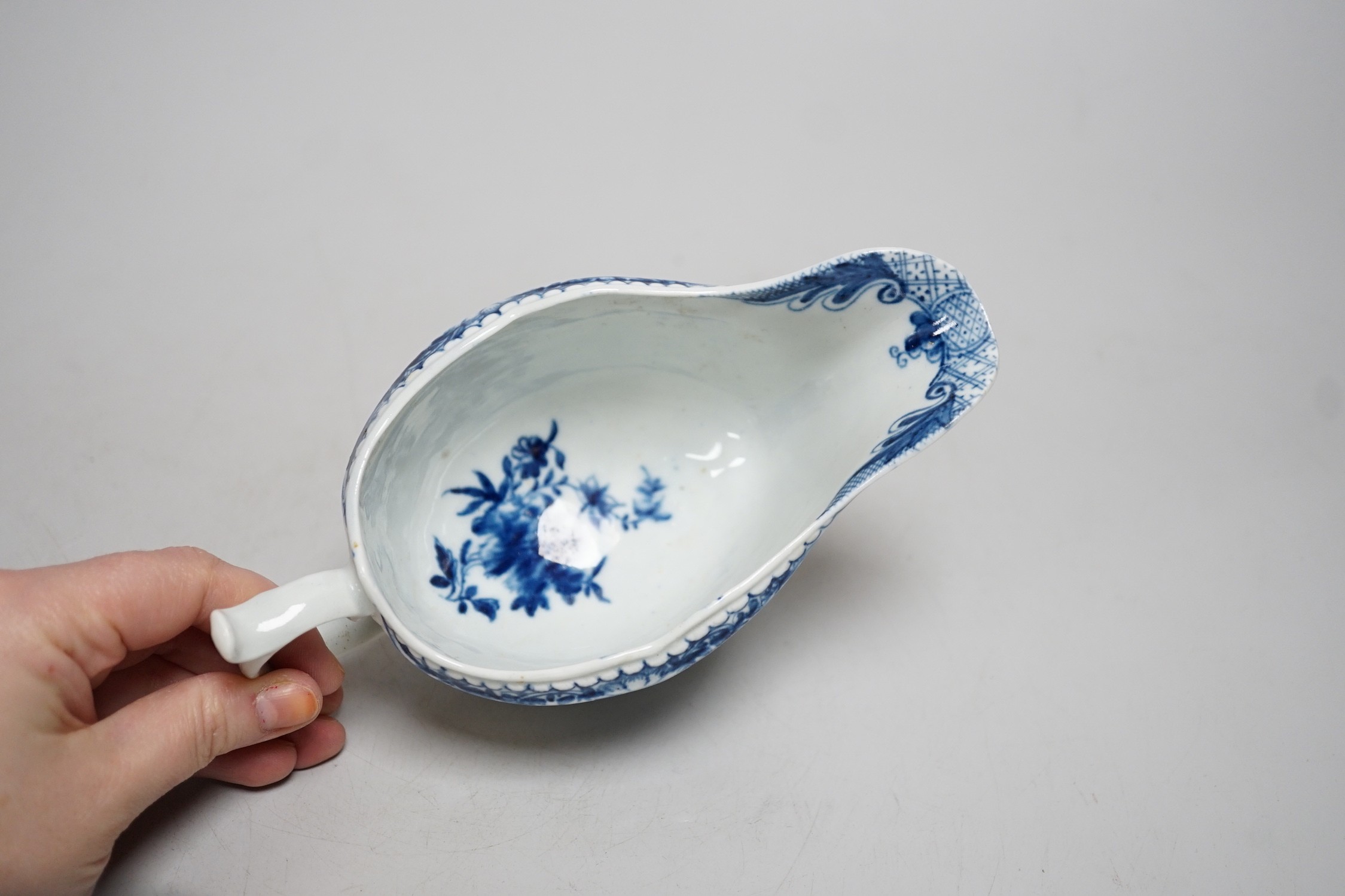 An 18th century Worcester ‘uncommon’ sauceboat painted with the Fisherman and Billboard Island (handle sprung at base and glued). 18cm wide